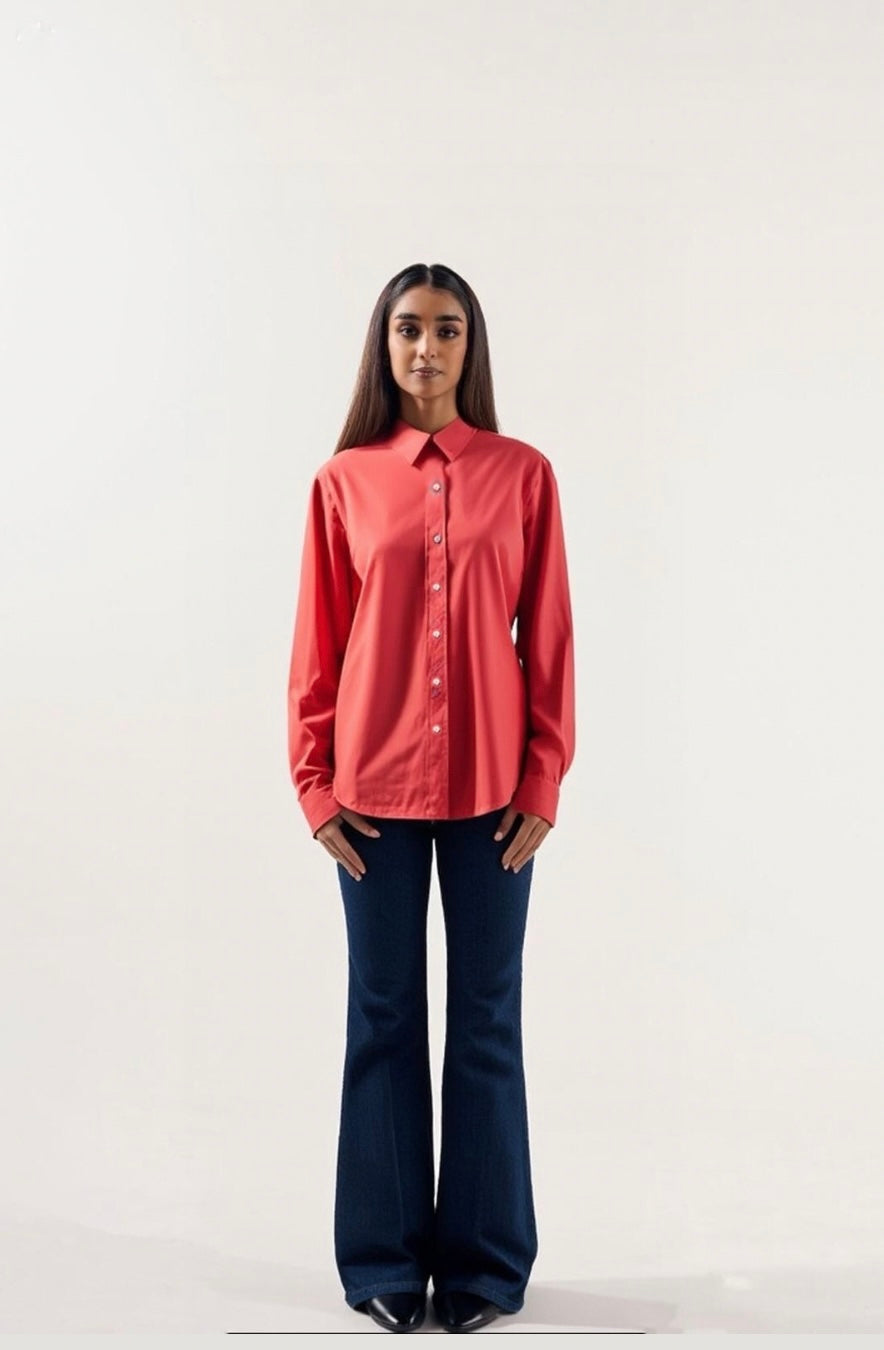 Woman wearing a red shirt and blue jeans on a white background