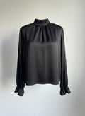 Black blouse with long sleeves on a light gray background ishq e amore