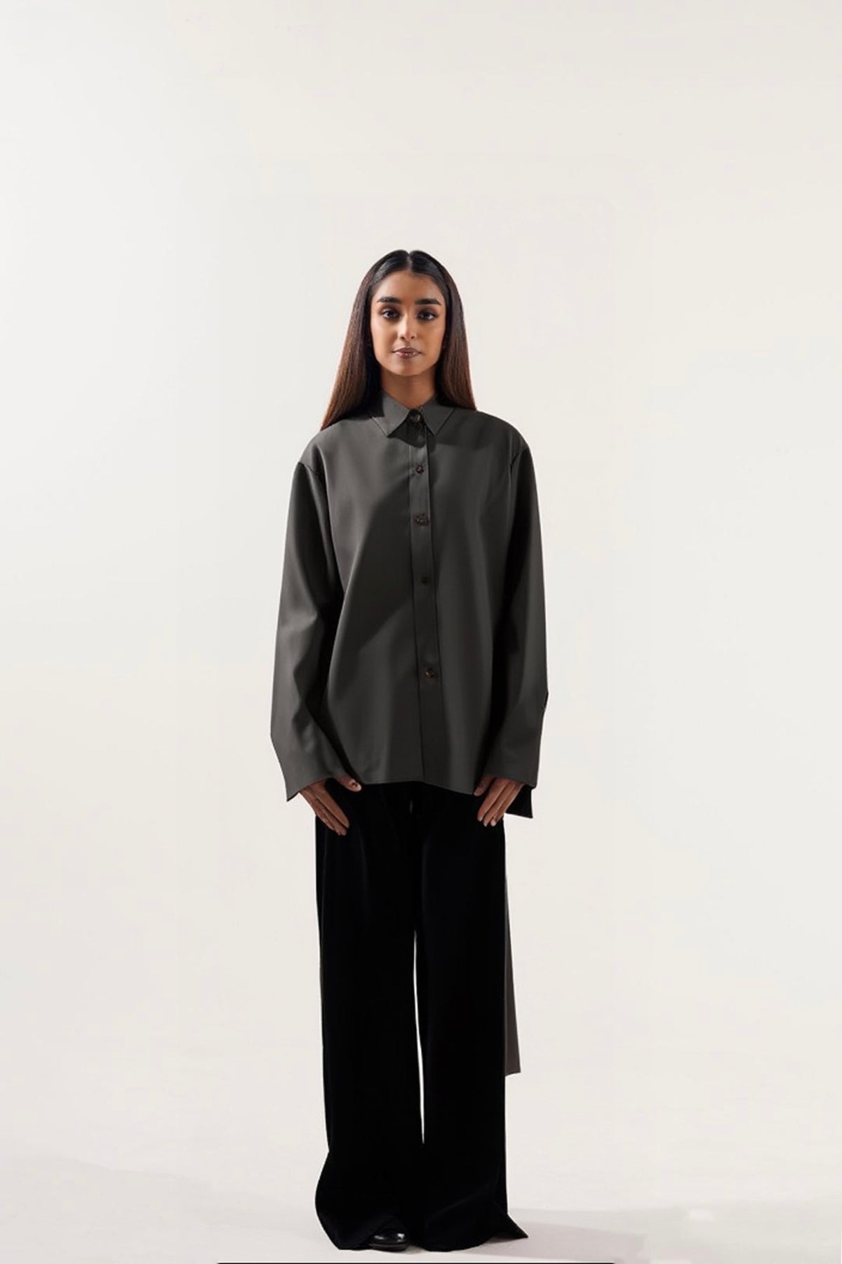 a dark gray shirt and black pants on a white background